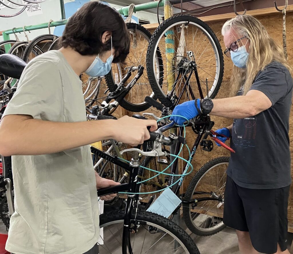 people working on a bike